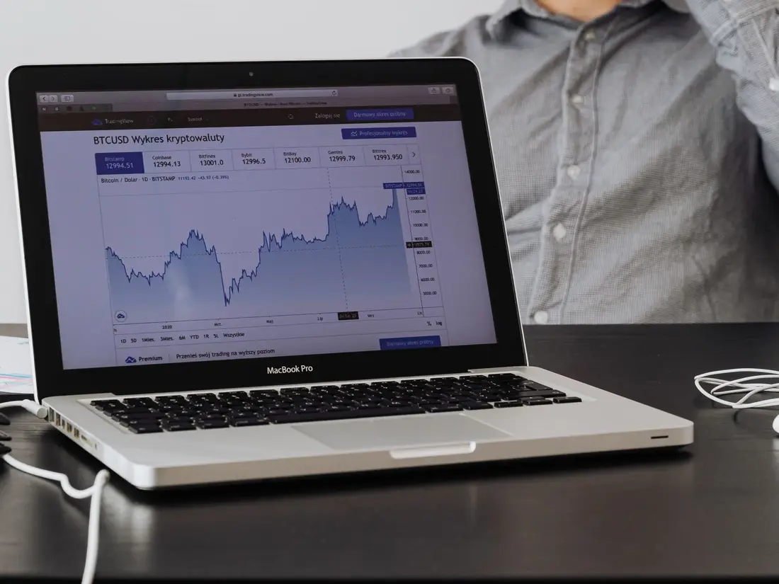 A laptop showing an open cryptocurrency price chart