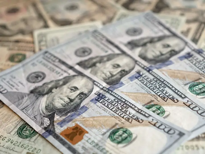 United States banknotes laid out across a desk